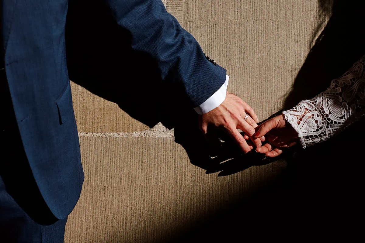 Deux mains se tiennent avec tendresse.