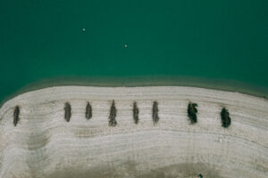 Vue aérienne plage galets et bois flotté aligné